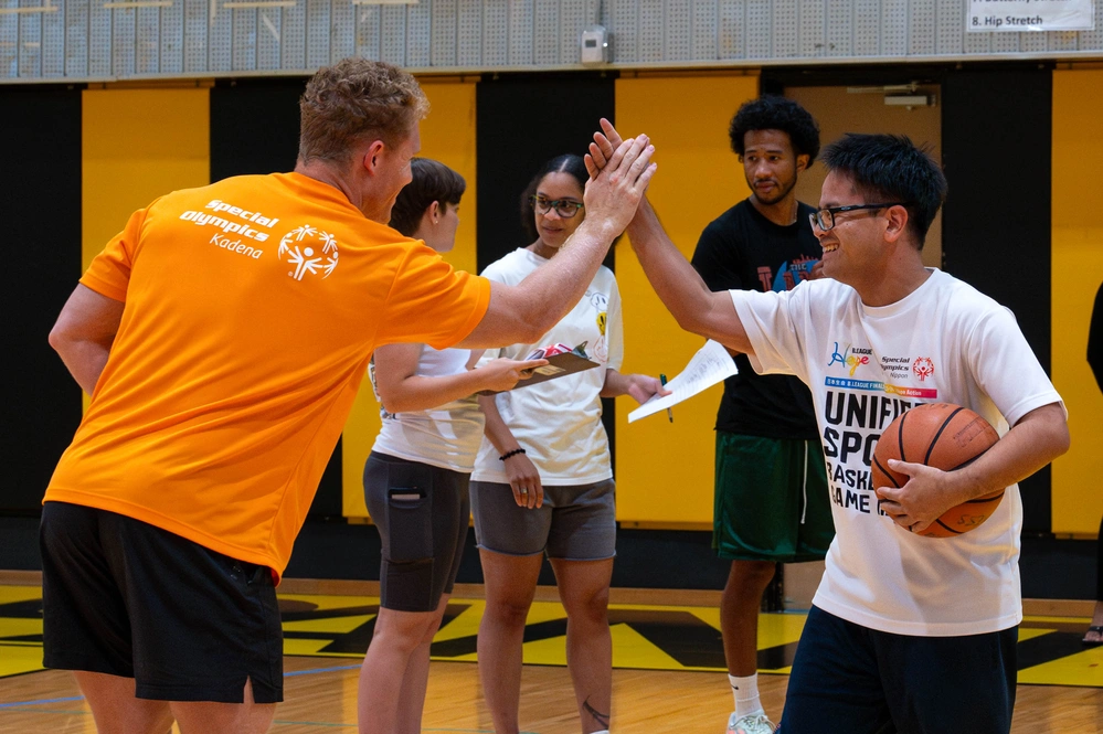 Athlete and volunteer sharing a high five