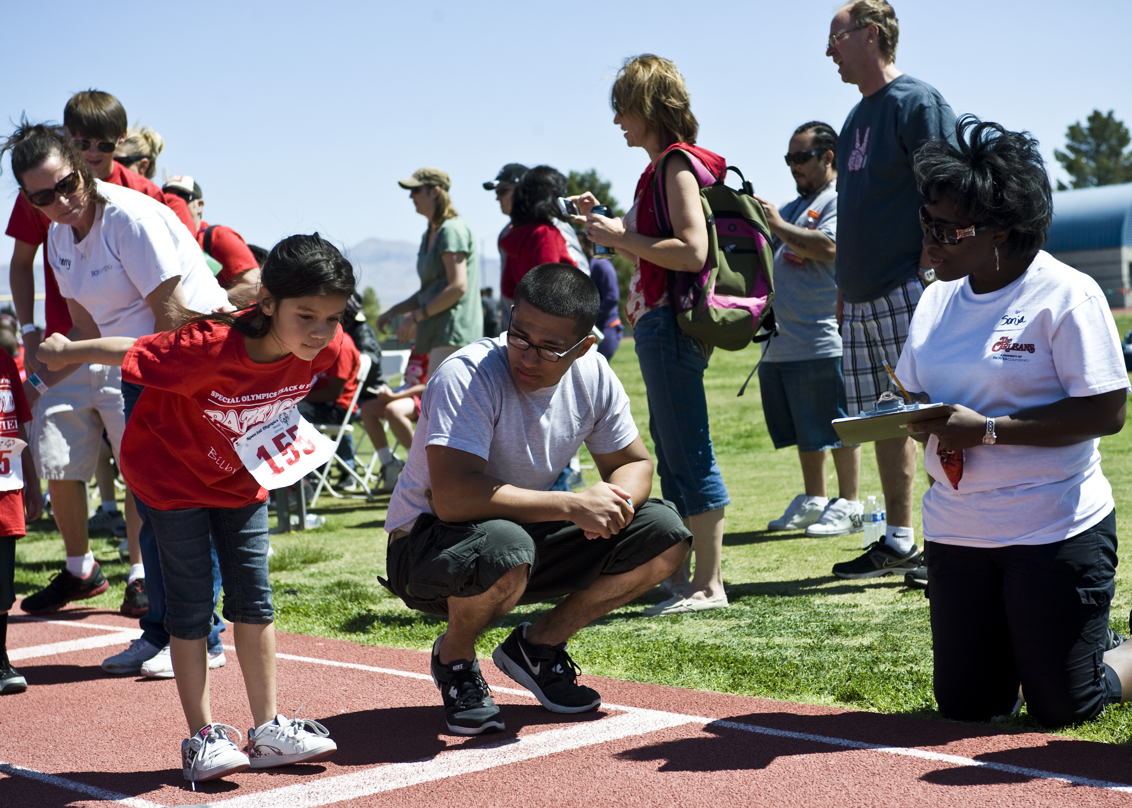 Volunteer waiting supportively beside an athlete
