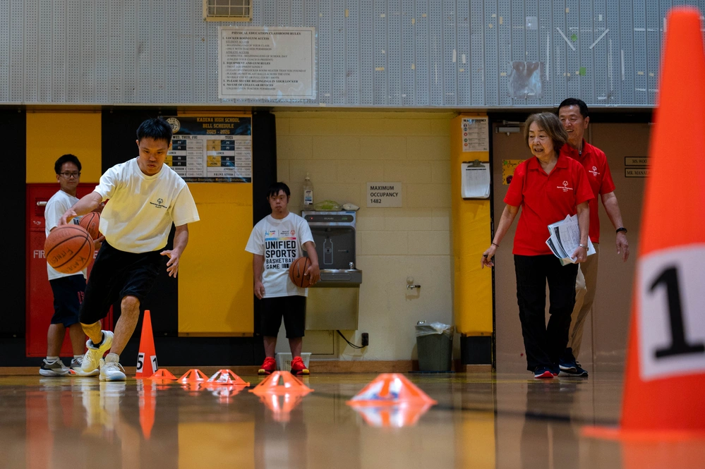 Athlete and volunteers in a busy sports environment